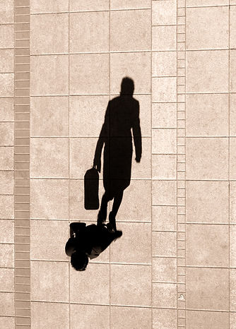 woman walking on side walk, shadows