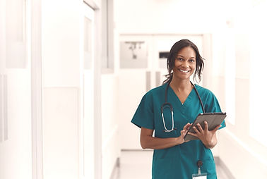 doctor, woman in green scrubs, with a clip board.